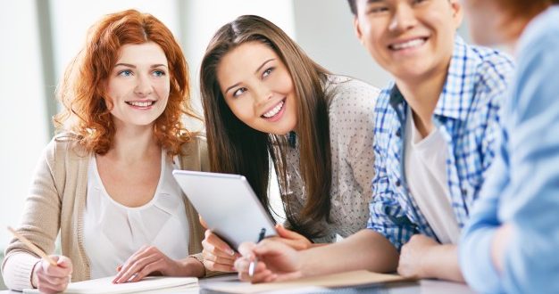 Group of people smile at a colleague